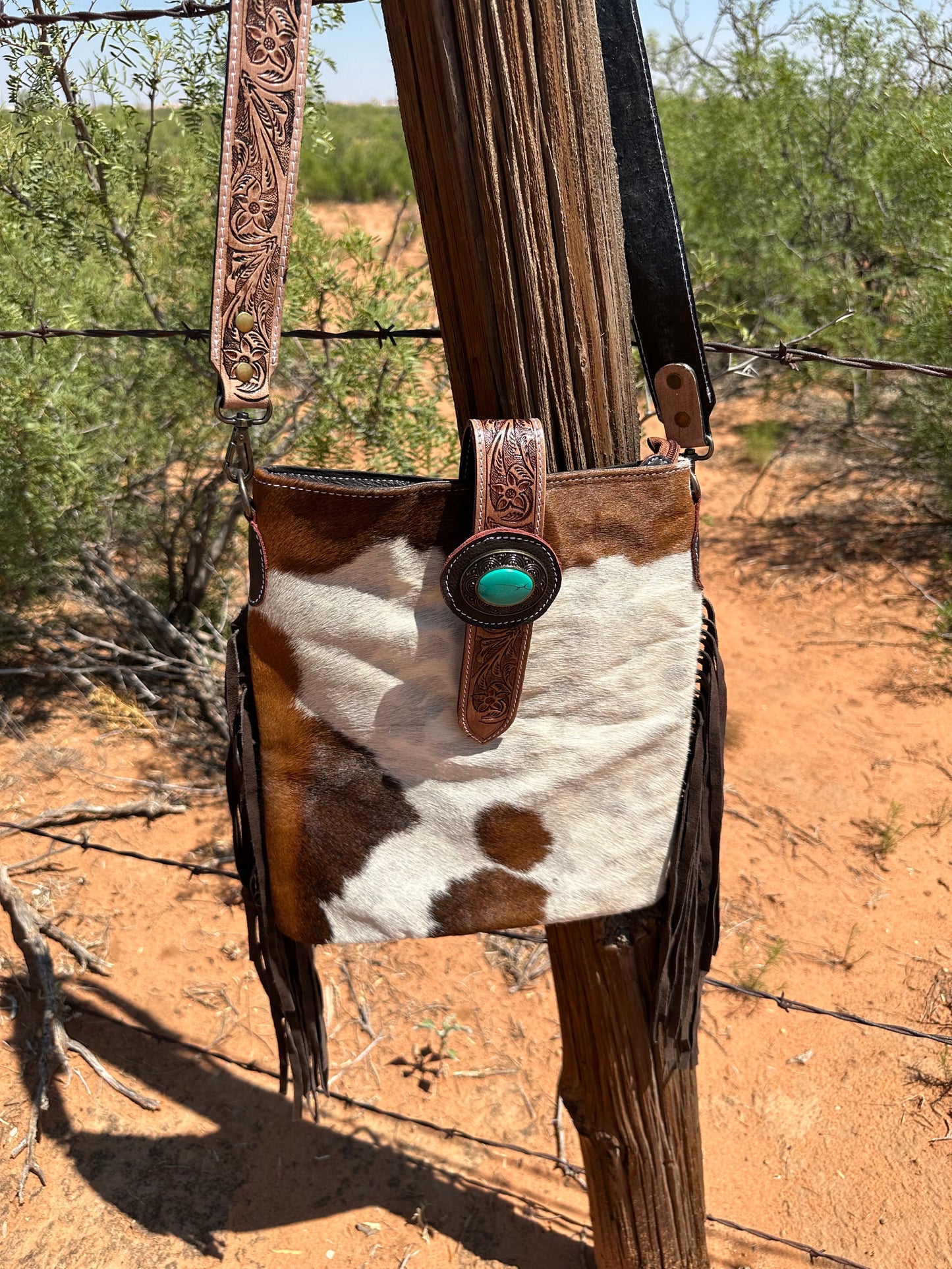 Cowhide Crossbody with Fringe and Emblem